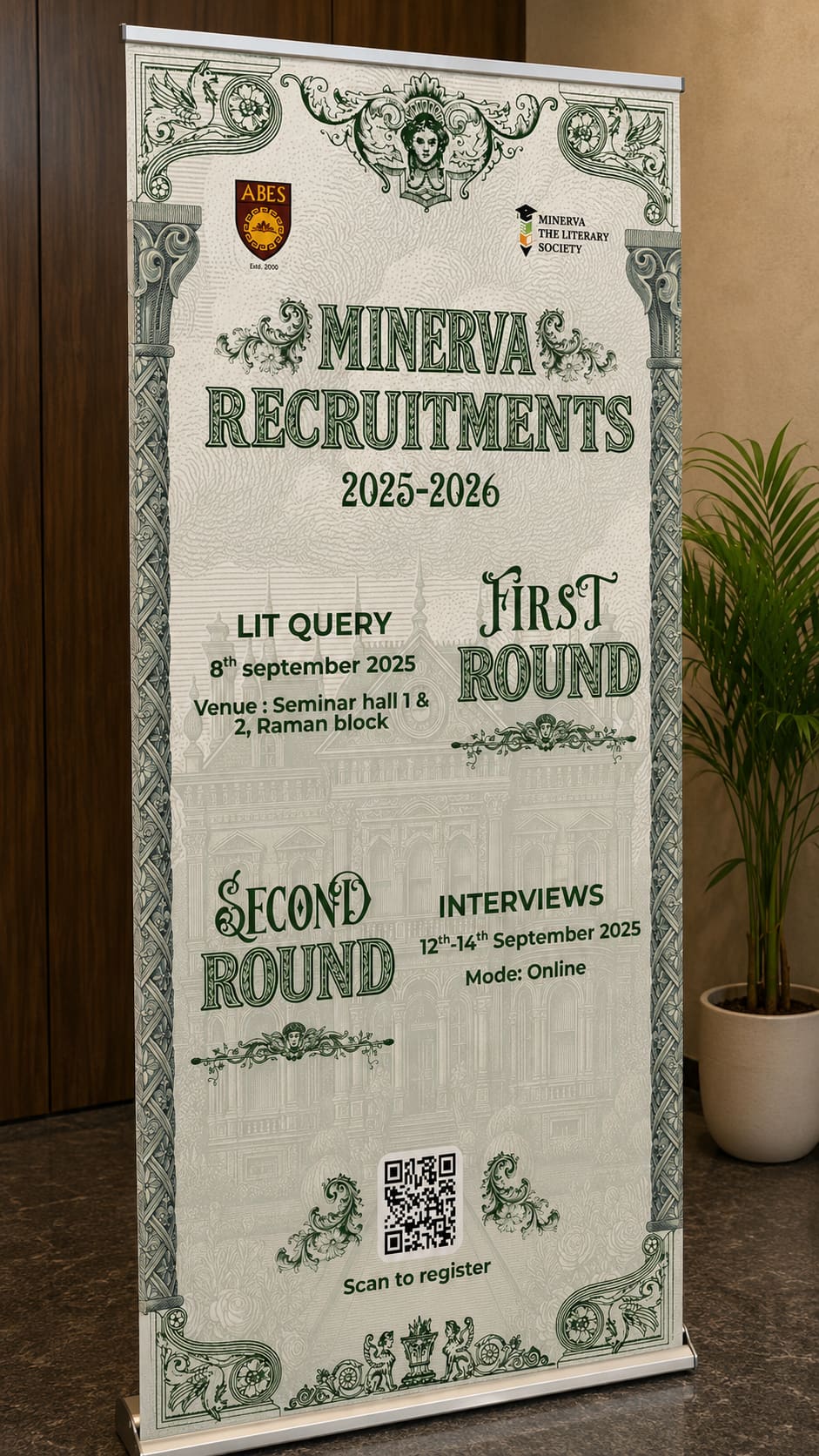 Recruitment standee, photographed in place. A two-round process printed at roughly two metres, designed to be read at a glance from a corridor.